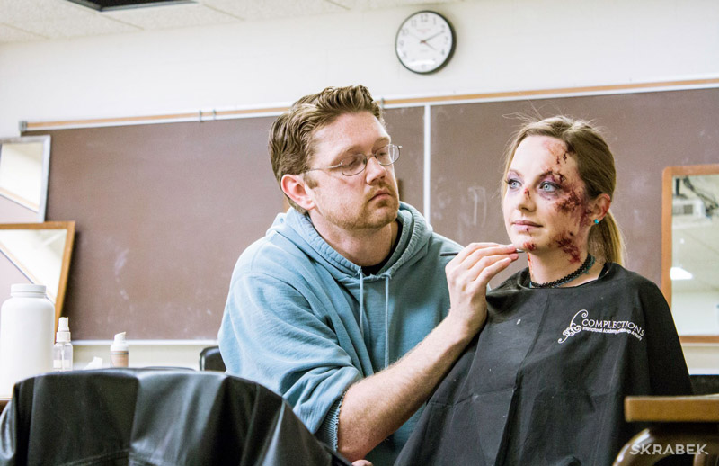 applying blood makeup on actress