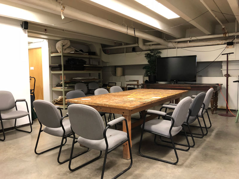 Room with table, chairs, and a TV