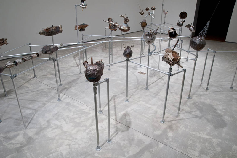Sculptures mounted on metal piping