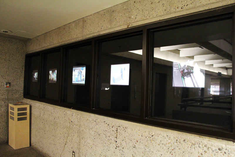 screens that face the hallway to showcase new media student work