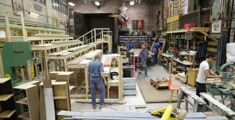 large shop with bleachers being constructed for stage production