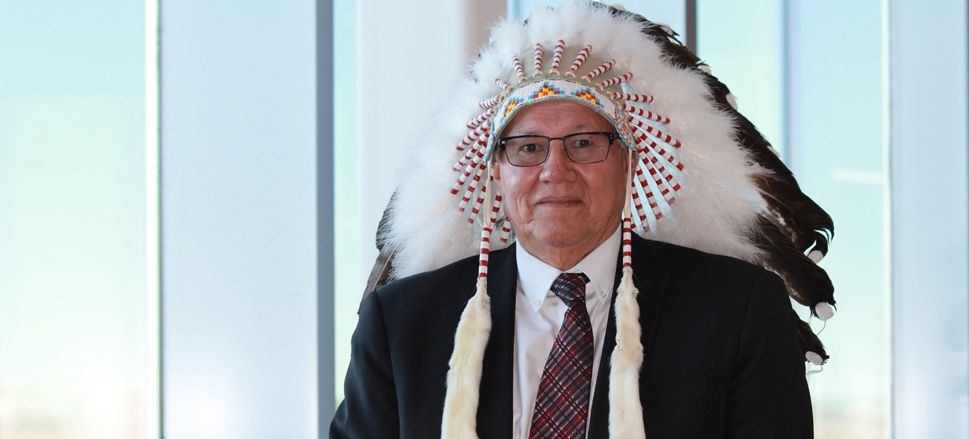 Portrait of Chancellor Charles Weaselhead in Blackfoot headdress