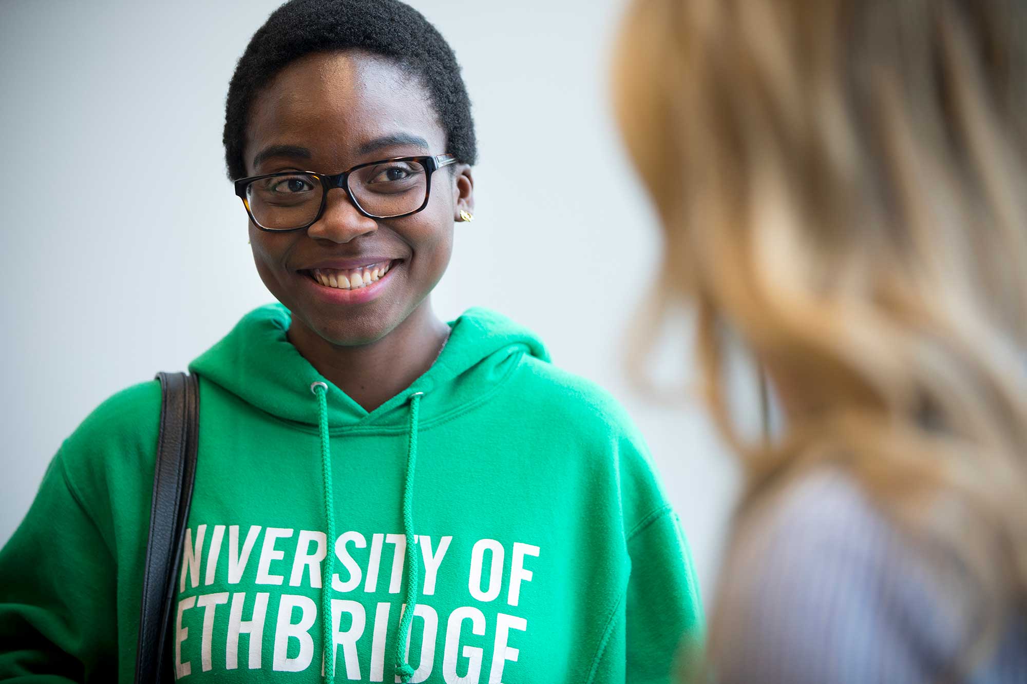 Smiling student wearing uLethbridge sweater