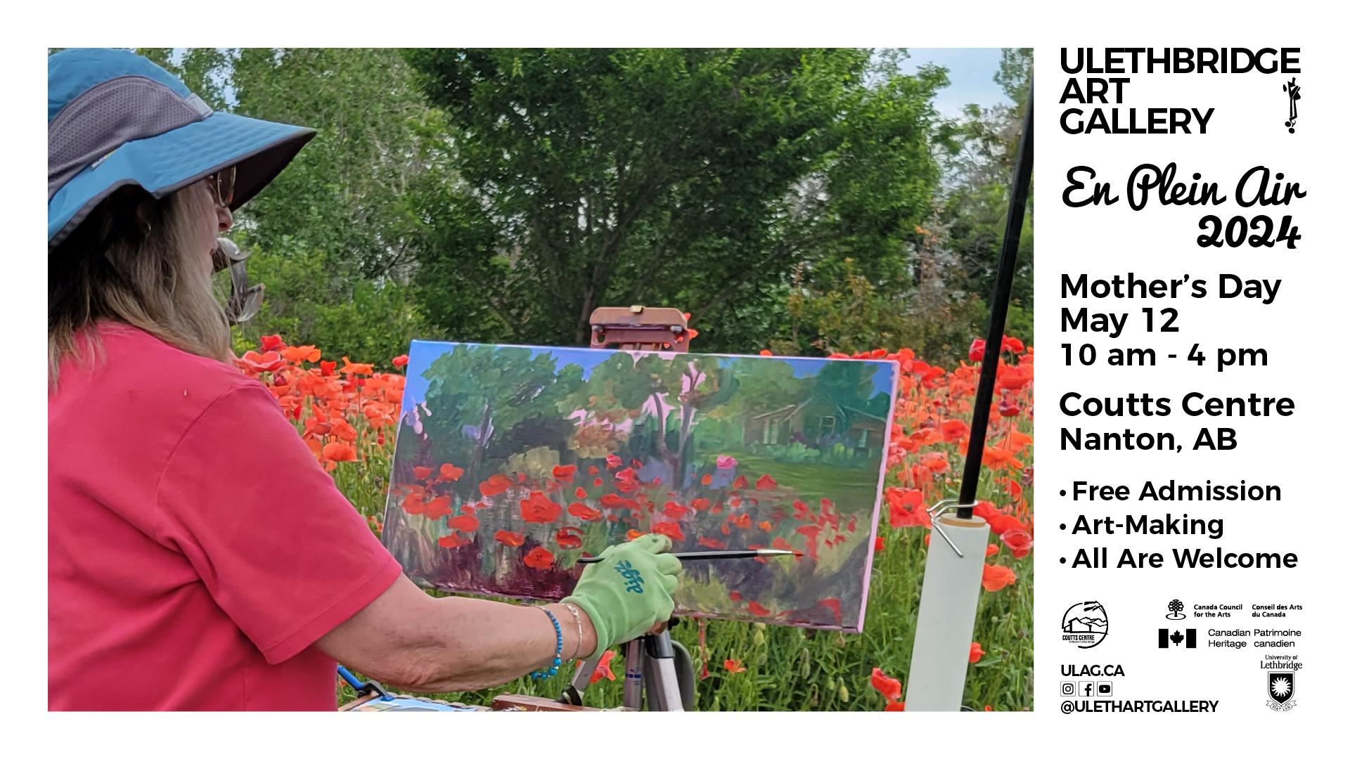 A seated artist wearing a red shirt, blue hat and green gloves, holding a small paint brush. Artist is working on a landscape painting with red poppies in the foreground, deciduous trees in the middle ground and a building in the background.
