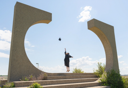 A graduate throws their mortarboard
