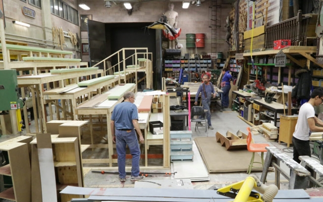 large shop with bleachers being constructed for stage production