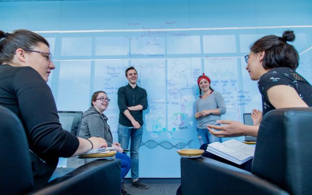 Students standing in front of a whiteboard