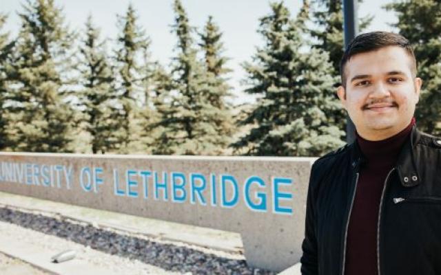 Male student headshot in front of ULeth sign