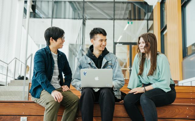 Three EAP students talking in the Winter Garden