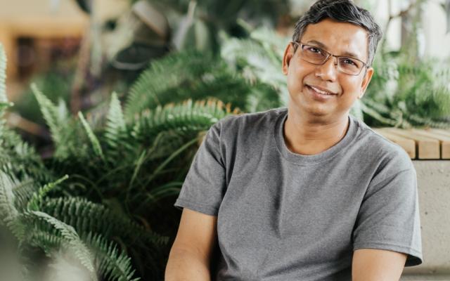 Male student headshot in Devonian Walkway sitting and smiling