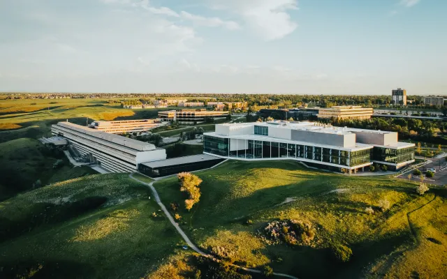 Overhead drone shot of the University of Lethbridge campus during the summer time. Picture primarily showcases the science and UHall buildings