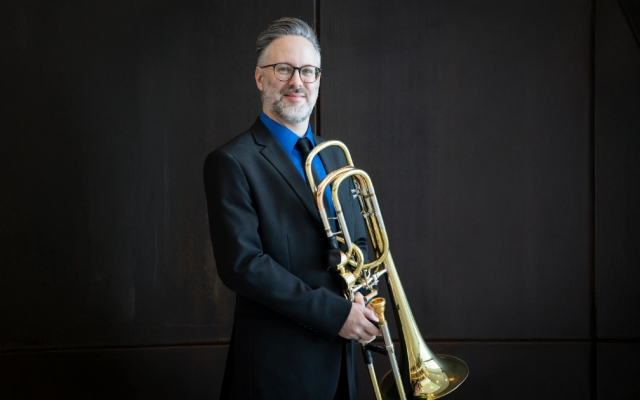 photo of Nick Sullivan holding a trombone