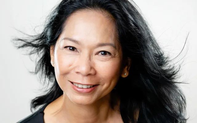 Photograph of Pat Lai Ngo Chan from the shoulders up.  She is a smiling woman with long black hair.