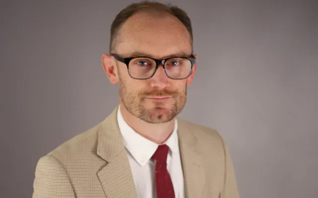 A headshot of Justin Blum.