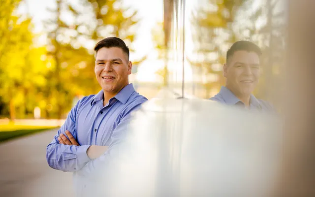 Student smiling at the camera during a fall photo shoot