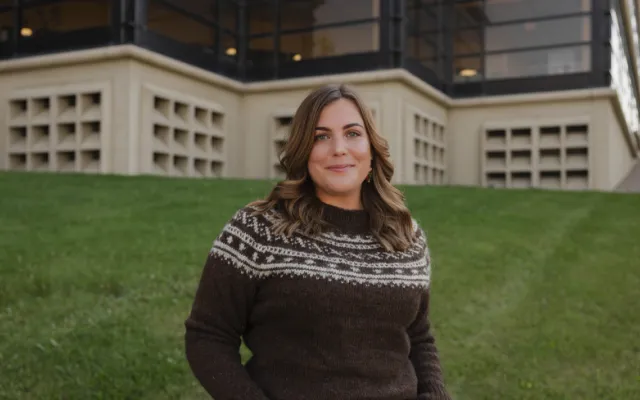 photo of Dr. Amy Mack outside in front of the University of Lethbridge Library building.
