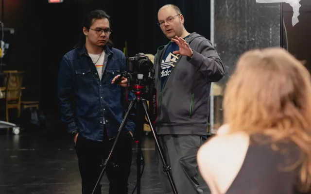 New Media Instructor Ryan Harper-Brown (right) instructs a student during a class.
