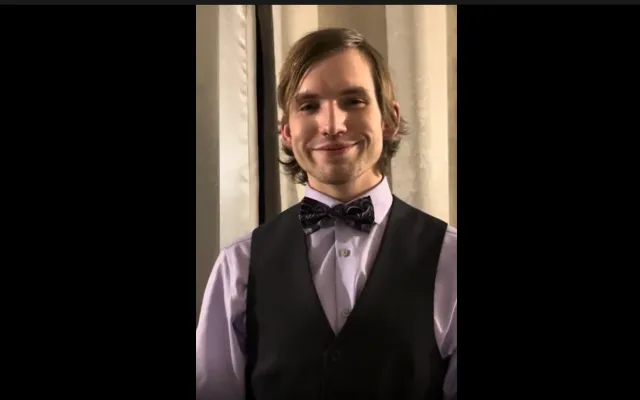 young man in bow tie and vest