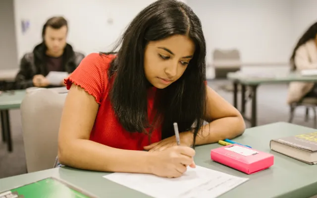 students writing at desks 