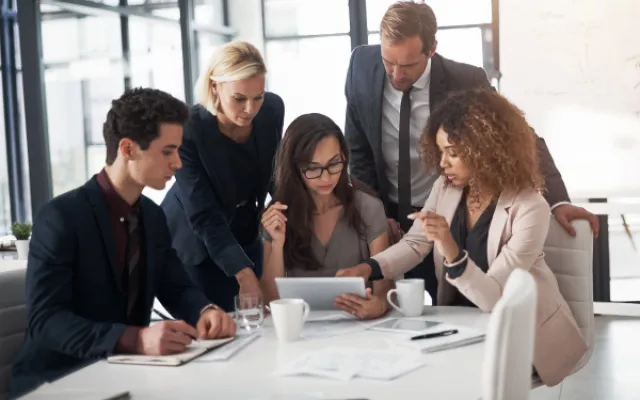 5 people at a table solving a problem 