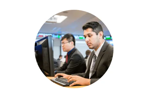 Maximize your degree circle stock Student in a suit working in front of a computer