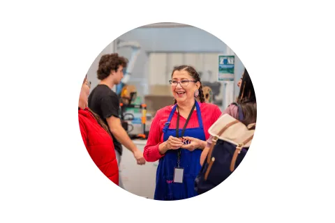 Events Circle Stock Test A photo of a women smiling and holding a wooden Oki sign