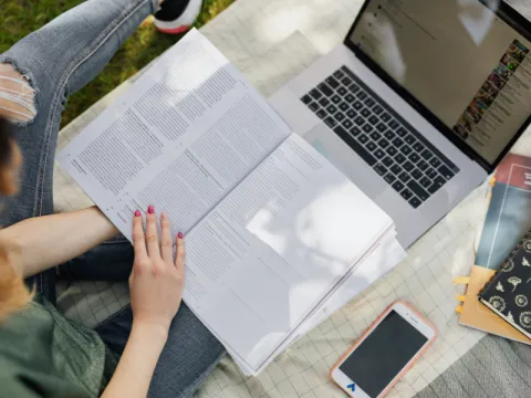 Accomidations Student with book and laptop