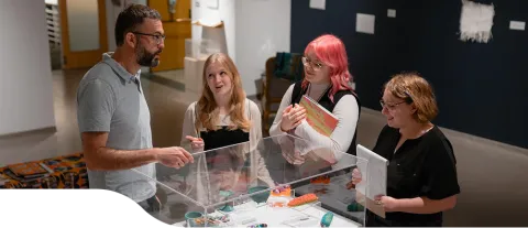 People gathered around an art exhibit at the Penny Building