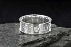 A silver band ring engraved with "FIAT LUX" and a sun emblem between the two words