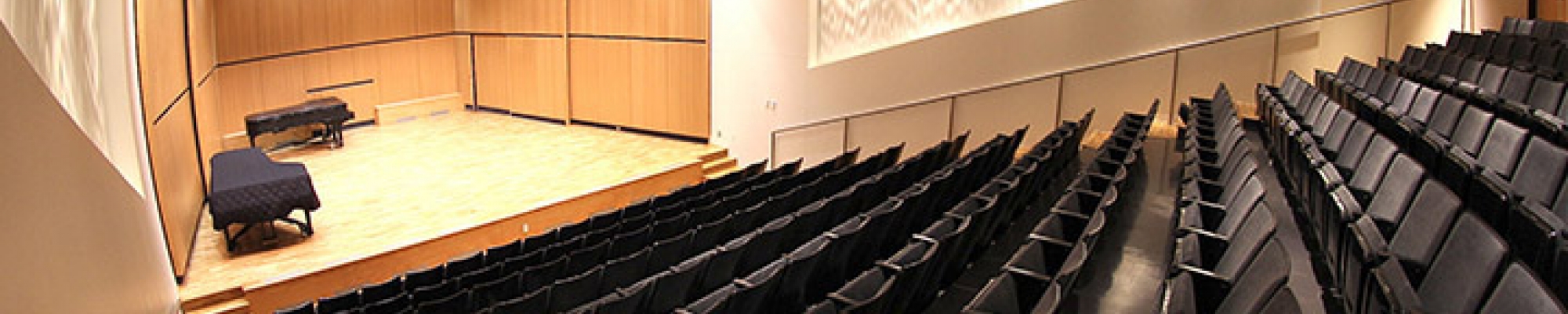 Recital hall stage with piano on it
