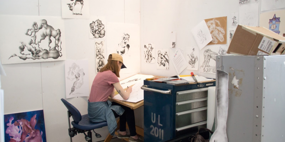 Desk with drawings on walls