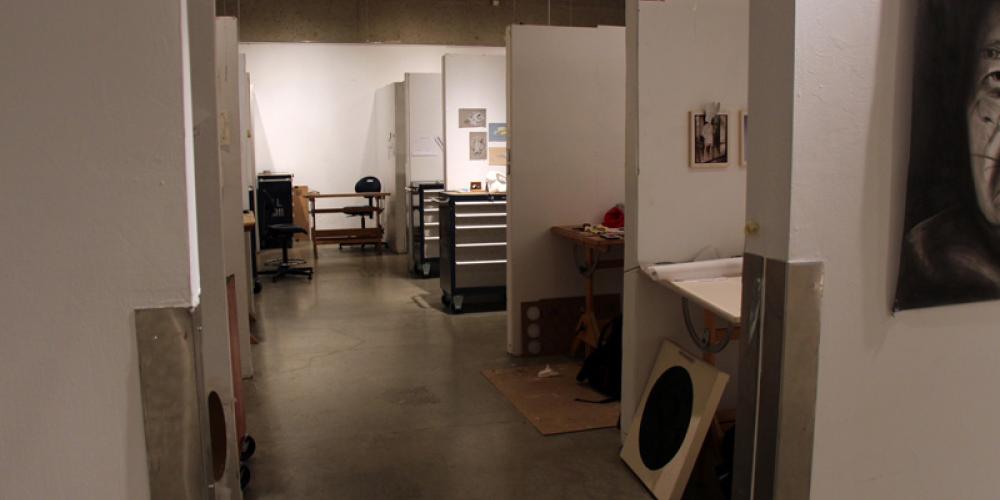 Art student sitting at individual desk