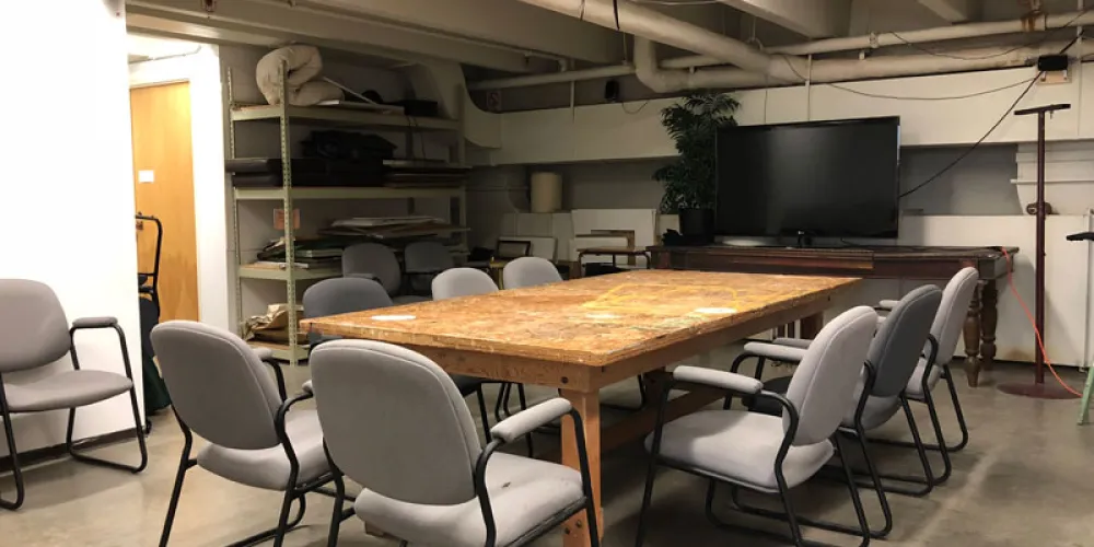 Room with table, chairs, and a TV