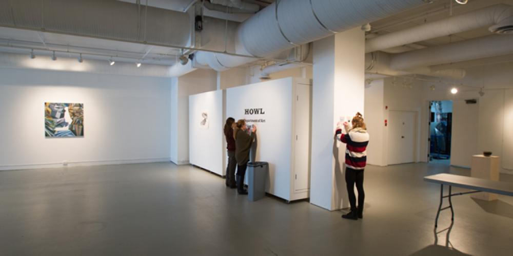 students taking down art in penny gallery