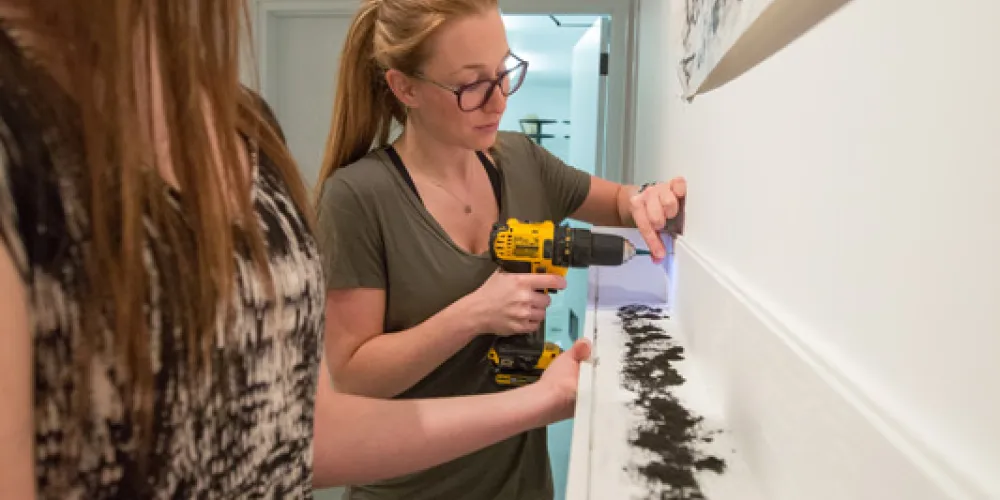 students taking down art in penny gallery
