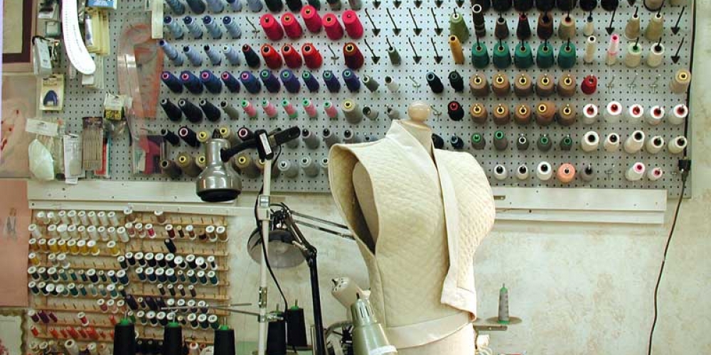 sewing station and rack of costumes