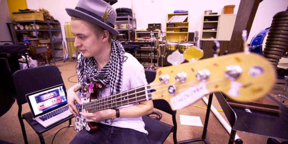 Student playing electric bass