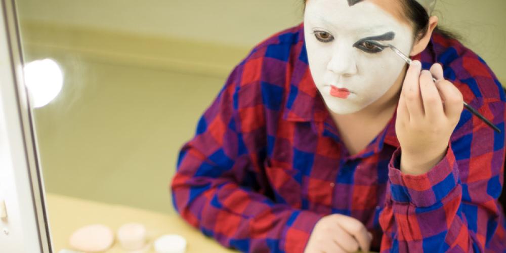 Student applying geisha-style makeup