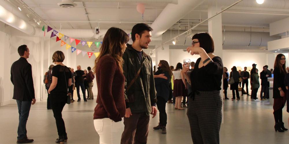Students gathered in Penny Building during gallery opening
