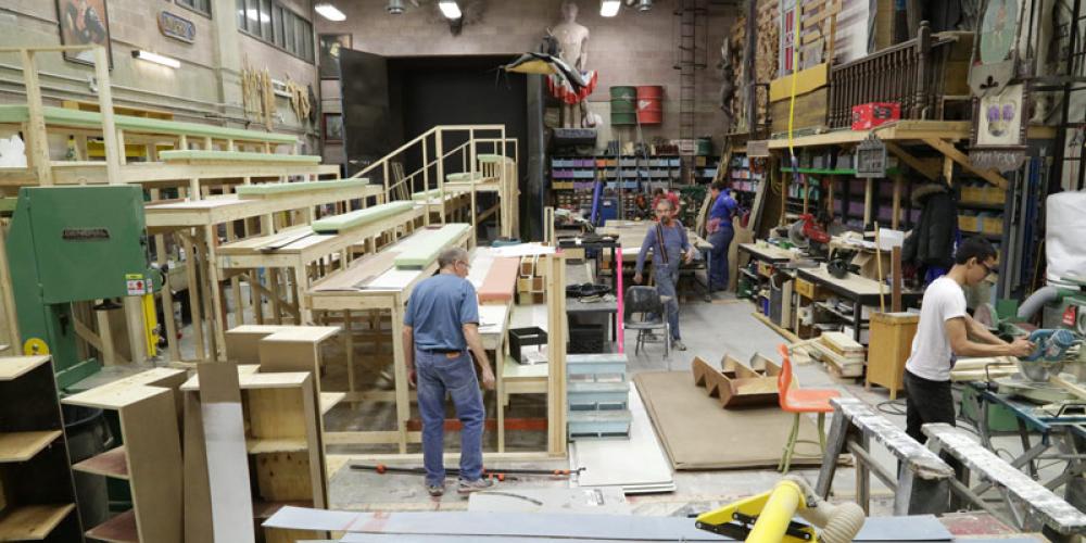large shop with bleachers being constructed for stage production