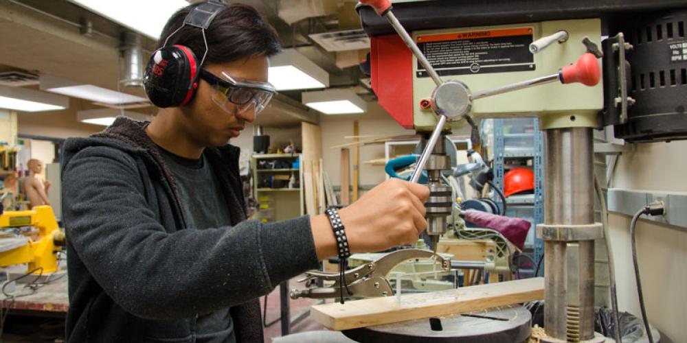student using drill press