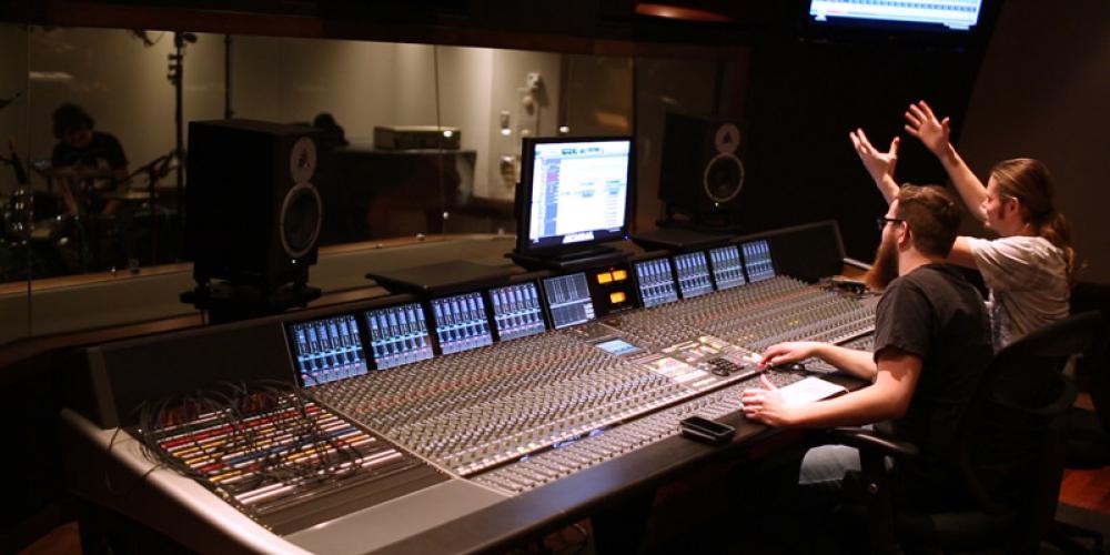 rear shot of student sitting at sound board