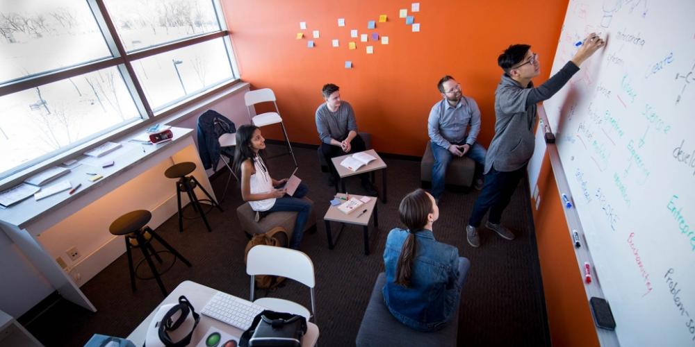 Group of students looking at a whiteboard