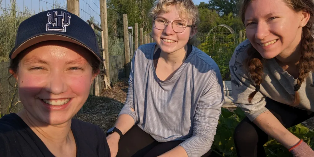 Three Volunteers in the Campus Roots Garden.