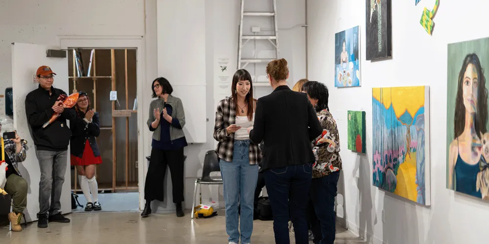 A student receiving an art award at Vibe Fest