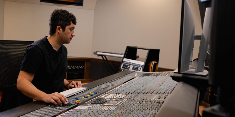 A sound engineer at a sound board.