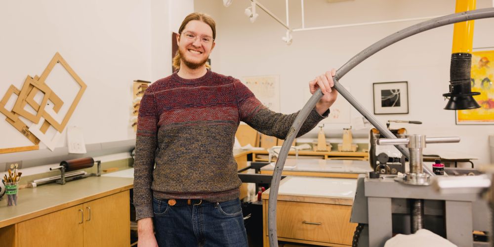 Student next to printing press