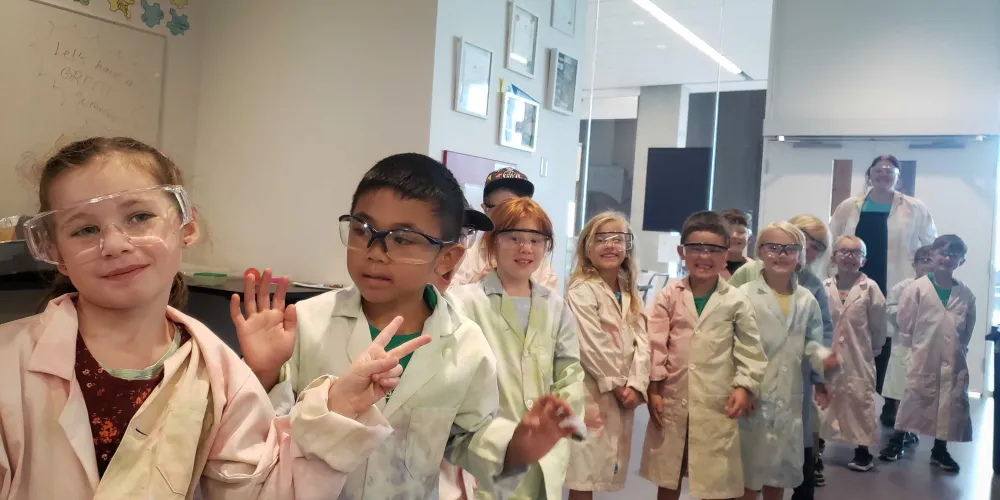 Kids standing in labcoats