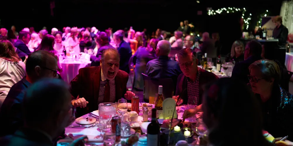 A group of people sitting at a table laughing.