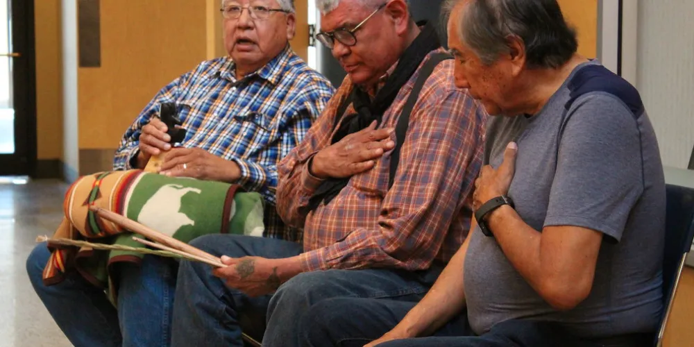 Indigenous Elders praying with sweetgrass